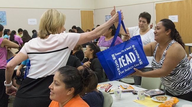 Hilary handing out school supplies