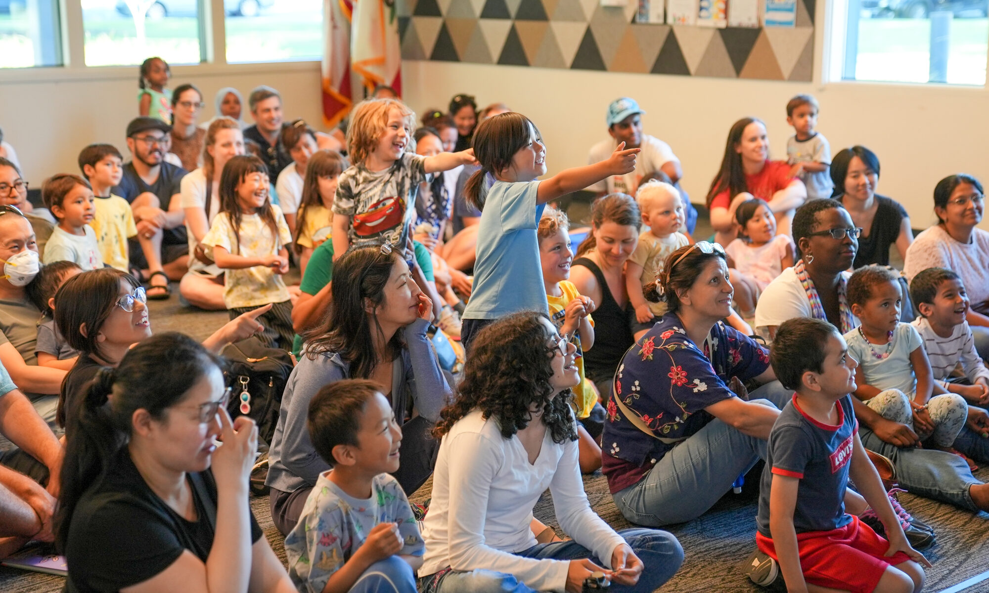 A group of happy families at a Coventry and Kaluza show at the Mission Branch Library. This show was part of the Summer Adventure series at The Santa Clara City Library.